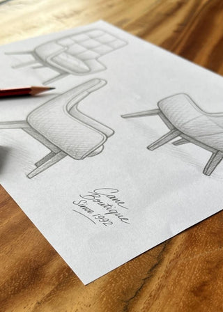 Chair design sketch on paper with a pencil and eraser on a wooden table