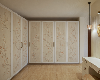 Room interior with decorative wall panels, a mirror, and a vanity table.
