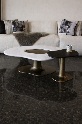 Modern coffee table with marble top and bronze base.