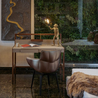 Modern interior with a desk, chair, and decorative elements.