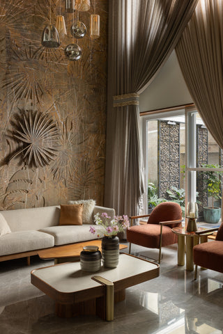 Modern living room with decorative wall, sofa, and coffee table.