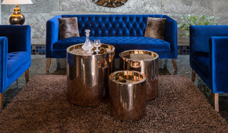 Modern metal center table with copper finish.