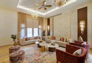Luxurious living room with elegant decor, including a chandelier, sofa, and armchairs.
