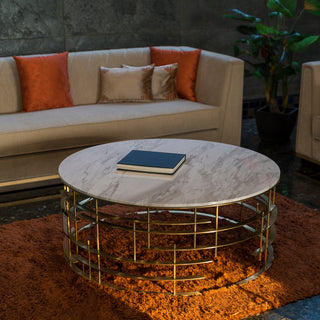 Round marble coffee table with gold base.