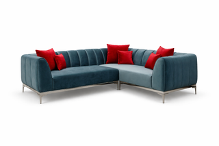 Blue sectional sofa with red cushions on a white background