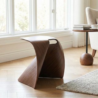 Modern wooden stool in a room with large windows and a rug.