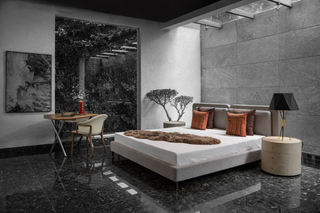 Modern bedroom with a bed, lamp, and decor in a stylish interior.