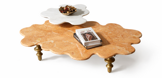 Wooden coffee table with a white flower-shaped object and a book on a white background