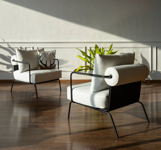 Modern armchairs with cushions in a sunlit room
