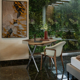 Modern interior with a table, chairs, and a laptop in front of a large abstract painting.