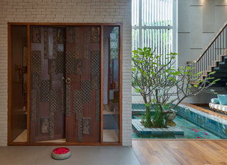 Decorative wooden sliding doors with a view of a pool and garden.