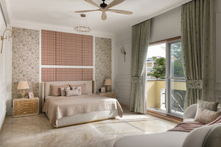 Modern bedroom with a bed, Blouce sofa, and large windows.