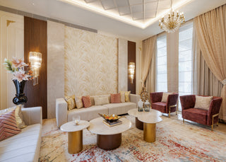 Luxurious living room with beige walls, marble patterns, and modern furniture.