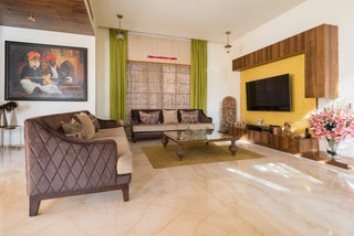 Living room with brown sofa, coffee table, and wall art