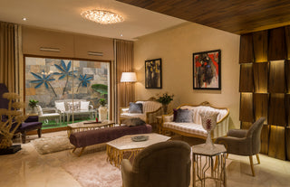 Luxurious living room with elegant furniture and decorative elements.