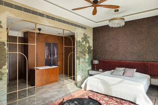 Modern bedroom with a suede leathr headrest bed, wardrobe section, and decorative elements.
