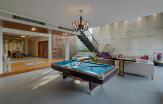 Modern living room with pool table and staircase
