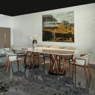 Dining room with a modern table and chairs, featuring a large abstract painting on the wall.