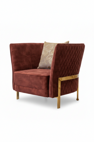 Red velvet armchair with gold accents on a white background
