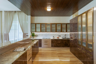Modern kitchen with wooden flooring and glass-front cabinetry