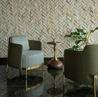 Modern interior with patterned wall, chairs, and a small table.