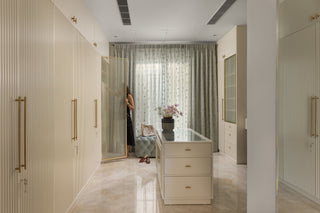 Modern interior with a glass cabinet, decorative items, and wordpobes.