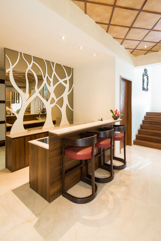 Decorative Bar table with chair and wall design.