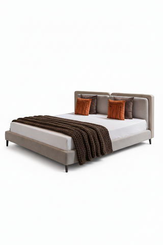 Modern bed with gray frame, white mattress, and decorative pillows on a white background