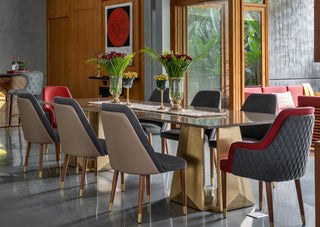 Modern dining area with a glass table and chairs in a stylish interior setting.