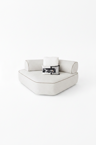 White sofa with black and white patterned cushions on a white background