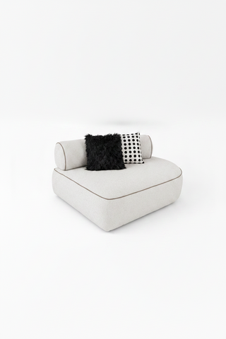 White sofa with black and white patterned cushions on a white background
